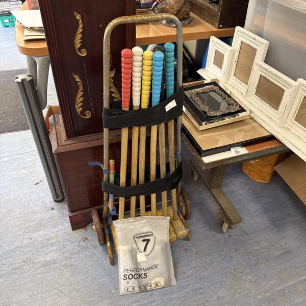 Vintage croquet set with mallet and bag of hoops for garden games.