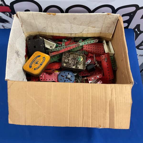 Vintage Meccano parts lot in a cardboard box.
