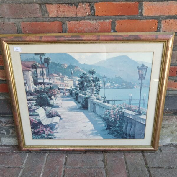 Large framed print of a charming coastal town scene.