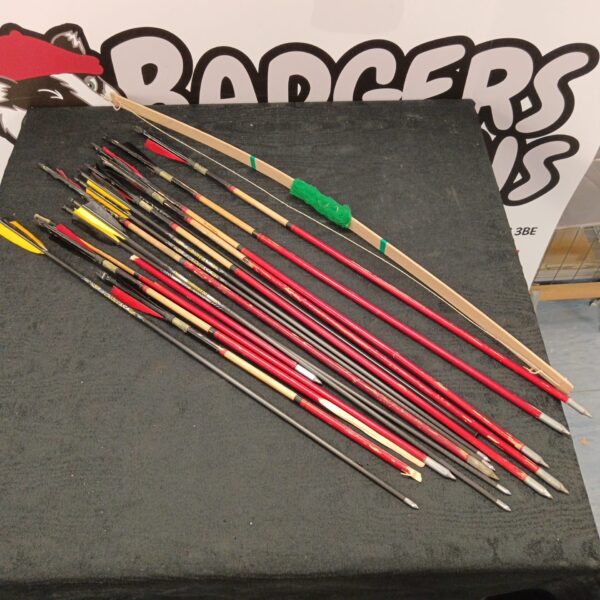 Vintage archery set with wooden arrows and a child's bow.