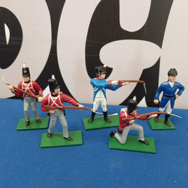Group of five vintage metal Napoleonic soldier figures on green bases.