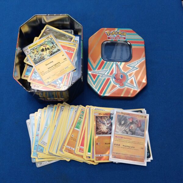 Pokémon card tin with holographic cards for collectors.