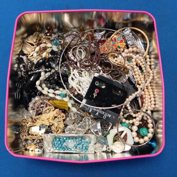 Assortment of vintage costume jewellery including necklaces and brooches.