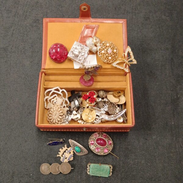 Vintage jewellery box filled with silver and costume jewellery pieces.