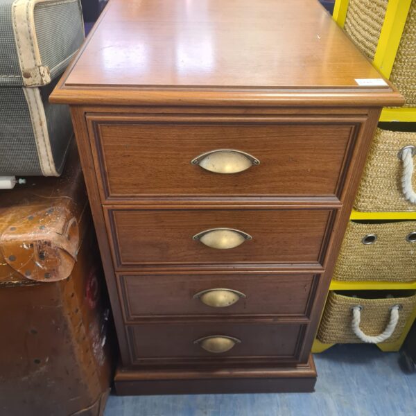 Vintage wooden chest of drawers with four drawers, antique bedroom furniture.