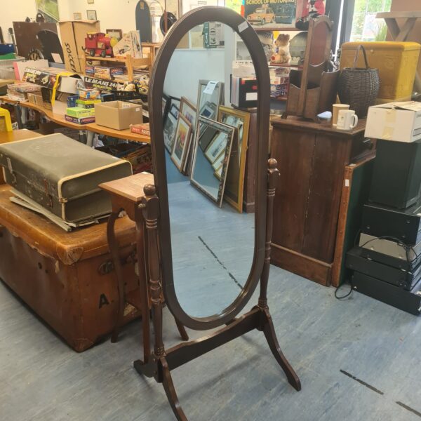 Vintage mahogany hall mirror with ornate frame and curved legs.