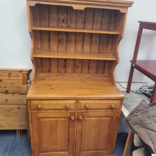 Large pine dresser with open shelving and cupboard storage.