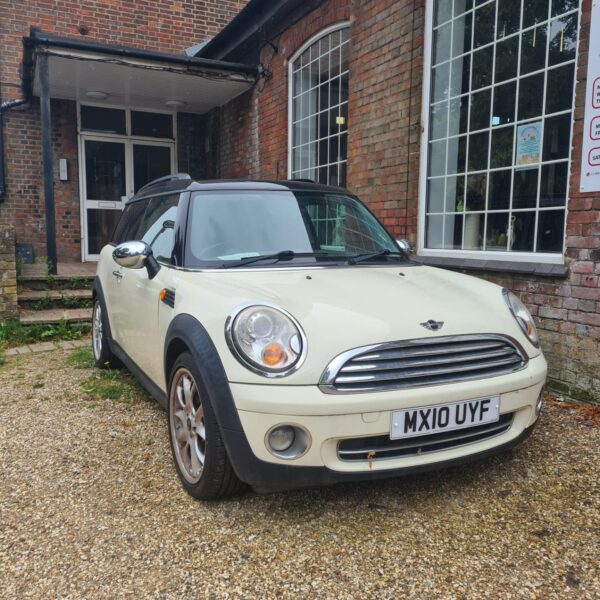 Front view of a cream Mini Cooper Clubman.