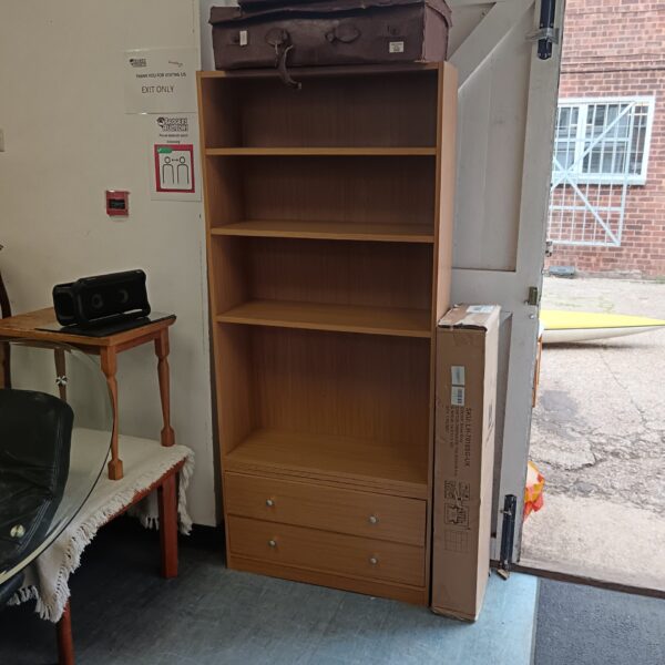 Oak effect bookcase with drawers for home storage.
