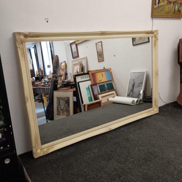 Large French style overmantle mirror with ornate gilt frame.