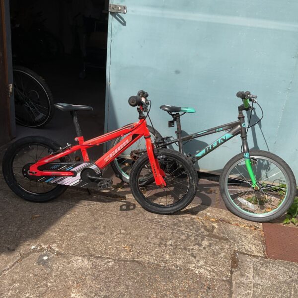 Red and blue childrens bike, BMX style, outdoor toy.