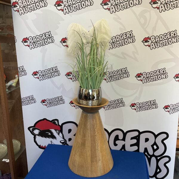Vintage wooden jardiniere plant stand with faux flowers on display.