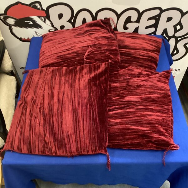 Four maroon velvet tassel cushions for home decor.