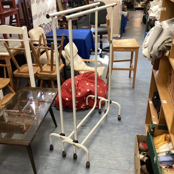 Two metal clothes rails with wheels for garment display.