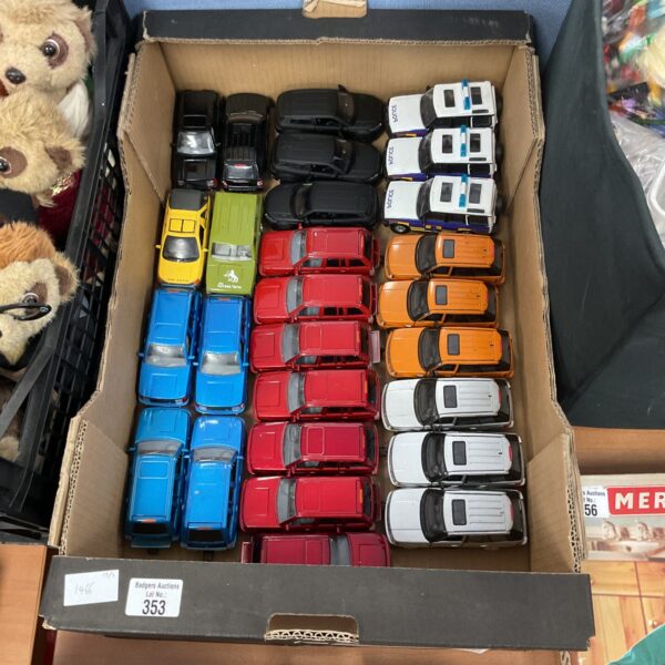 A box full of colourful Land Rover diecast models.