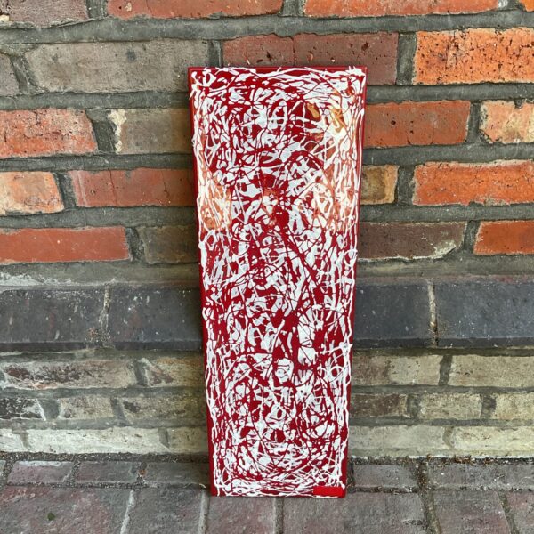 Vibrant red J Collins art glass wall panel with abstract swirls.