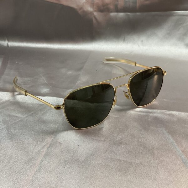 Gold framed vintage aviator sunglasses with dark lenses.