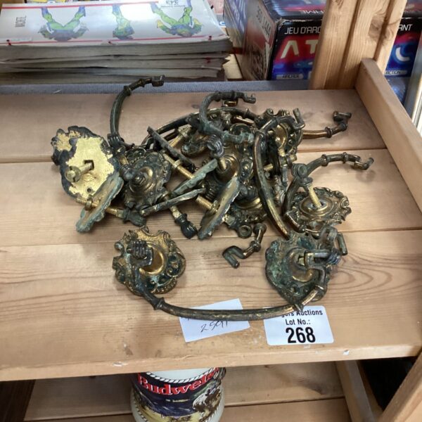 Vintage brass drawer handles in a lot, antique hardware.
