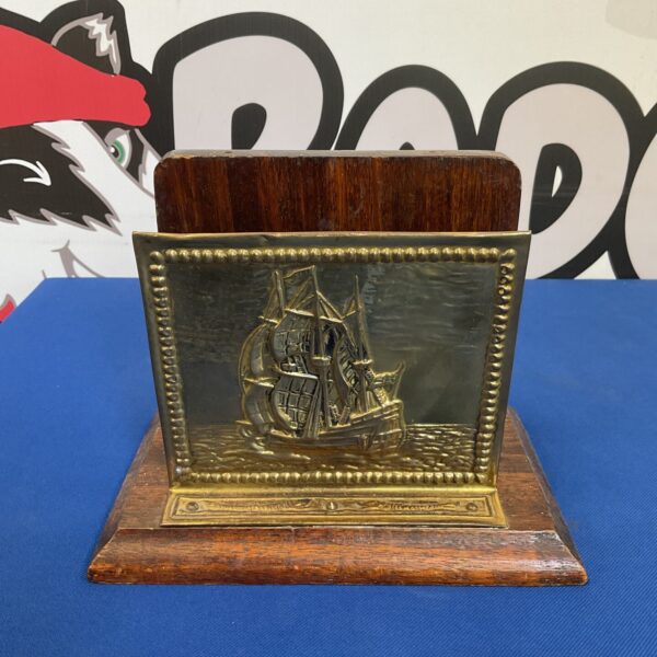 Vintage brass letter rack with nautical ship design.