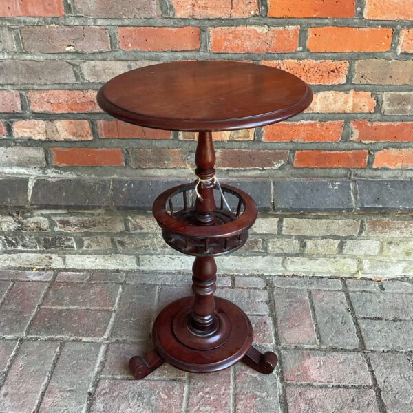 Antique Victorian mahogany sewing table with lower shelf.