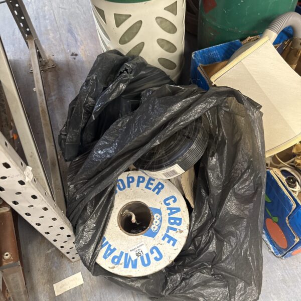 Assorted used cable reels in black bags, ideal for wiring projects.