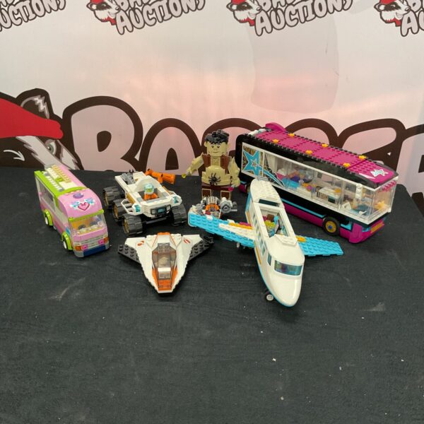 Lego vehicle lot including a colourful tour bus and off-road vehicle.