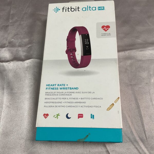 Coral Fitbit Alta HR fitness tracker displayed in its original box.