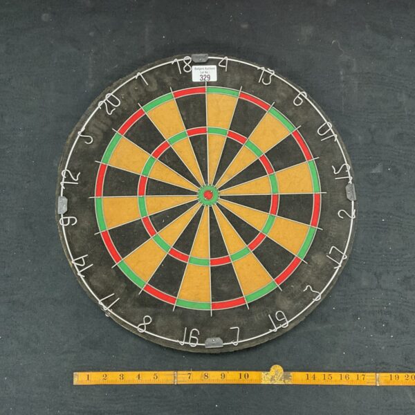 Traditional dartboard mounted on a wall, perfect for game rooms.