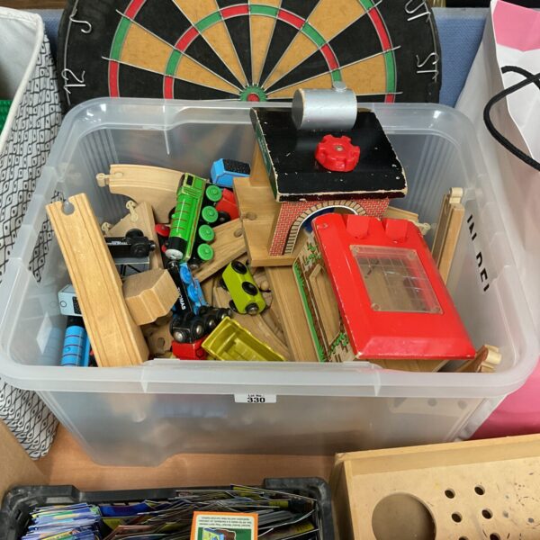 Wooden toy train set and colourful building blocks in a storage box.