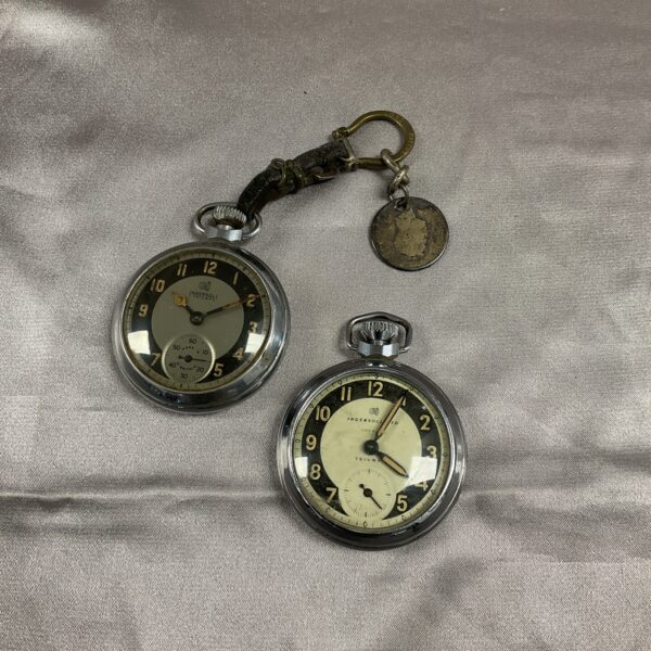 Vintage Ingersoll pocket watch pair, silver-plated, collectible timepieces.