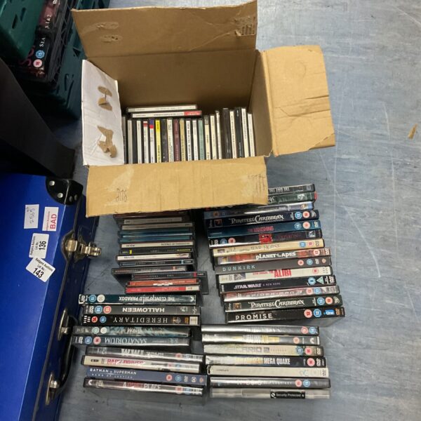 Sealed CD and DVD bundle, a diverse media collection.