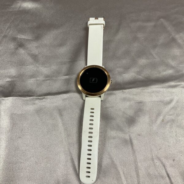 Garmin Vivoactive 3 fitness watch on a white surface.