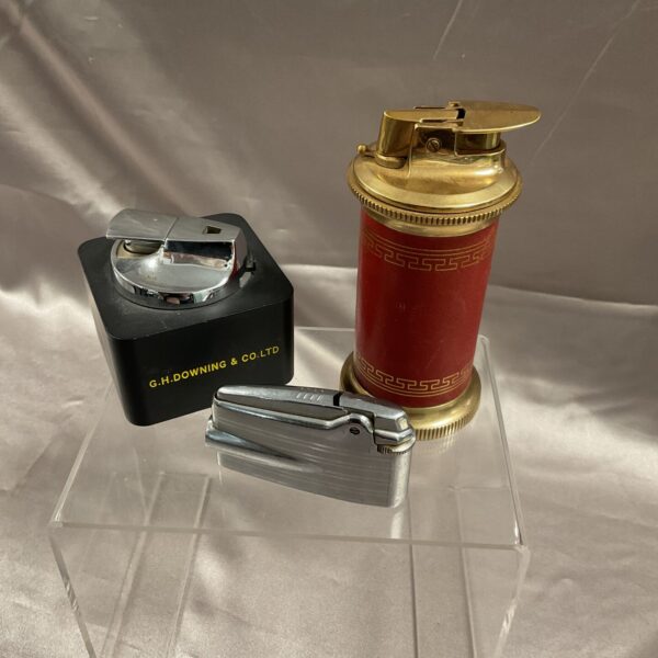 Vintage Ronson gas lighter with red and gold detailing.