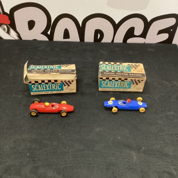 Two vintage Triang Scalextrix cars in vibrant red and blue.