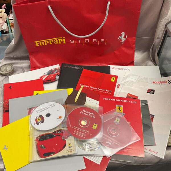 Ferrari literature collection including DVDs, CDs and booklets.
