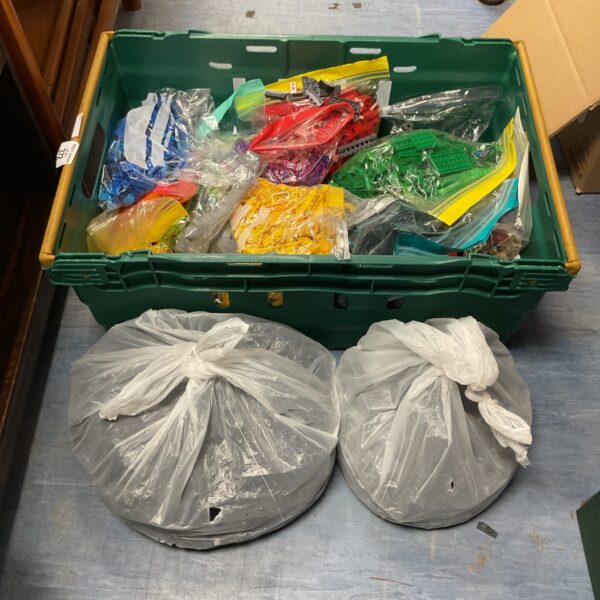 Crate filled with a large mixed lot of Lego bricks.