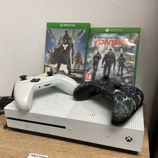 Black Xbox One console with controllers and Destiny game.