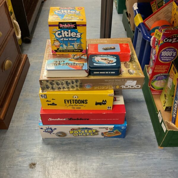 Sealed Eyetoons game within a mixed board game bundle.