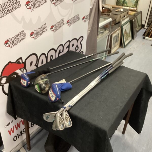 Vintage Ping Gle golf club set with Callaway woods on display.