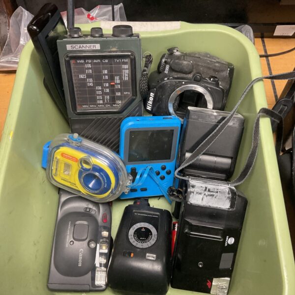 Vintage camera and radio lot with Canon and Nikon cameras.