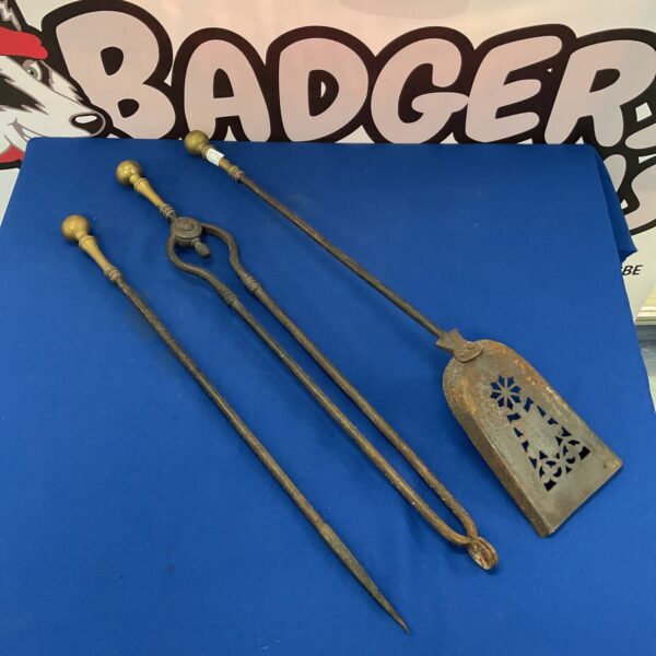 Antique Victorian fireplace tool set with ornate detailing.