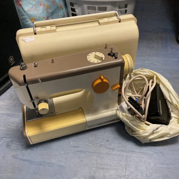 Vintage Frister & Rossman Cub 4 electric sewing machine in cream and black.