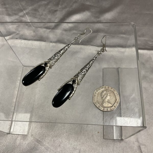 Antique silver drop earrings with black onyx stones.