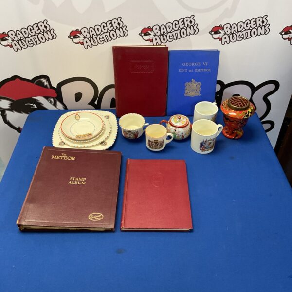 Mixed lot of vintage stamps and china collectibles on display.