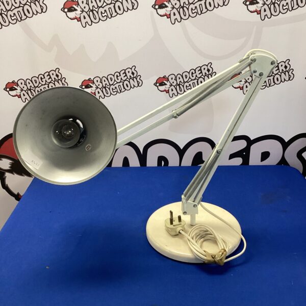 Vintage Anglepoise lamp with adjustable arm and circular base.