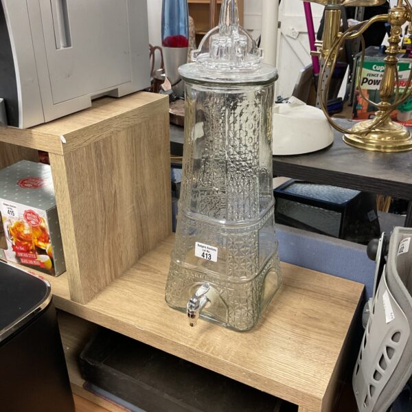 Vintage Eiffel Tower drink dispenser with tap, clear glass.