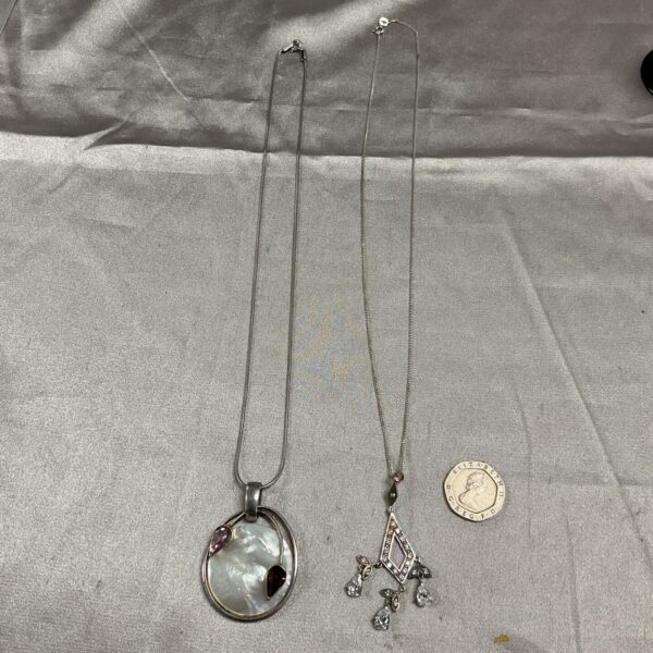 Silver necklace with a lustrous mother of pearl pendant.