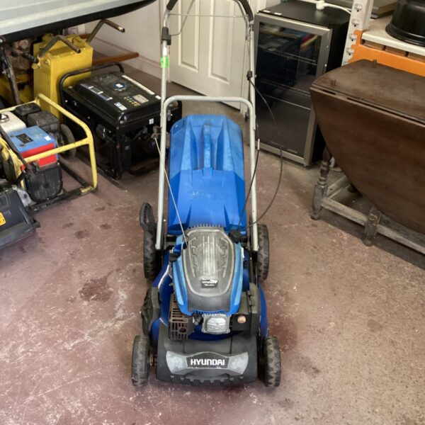 Blue Hyundai petrol lawnmower for garden maintenance.