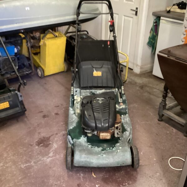 Used Hayter Harrier 56 petrol lawnmower for garden maintenance.