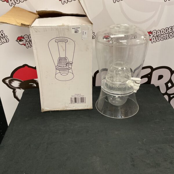 Clear plastic drinks dispenser with a tap for serving beverages.